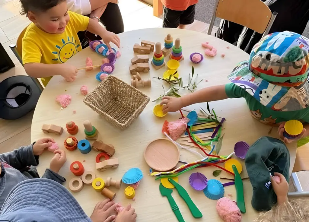 Children building with loose parts at Little Nestlings preschool, encouraging problem-solving and creativity.”