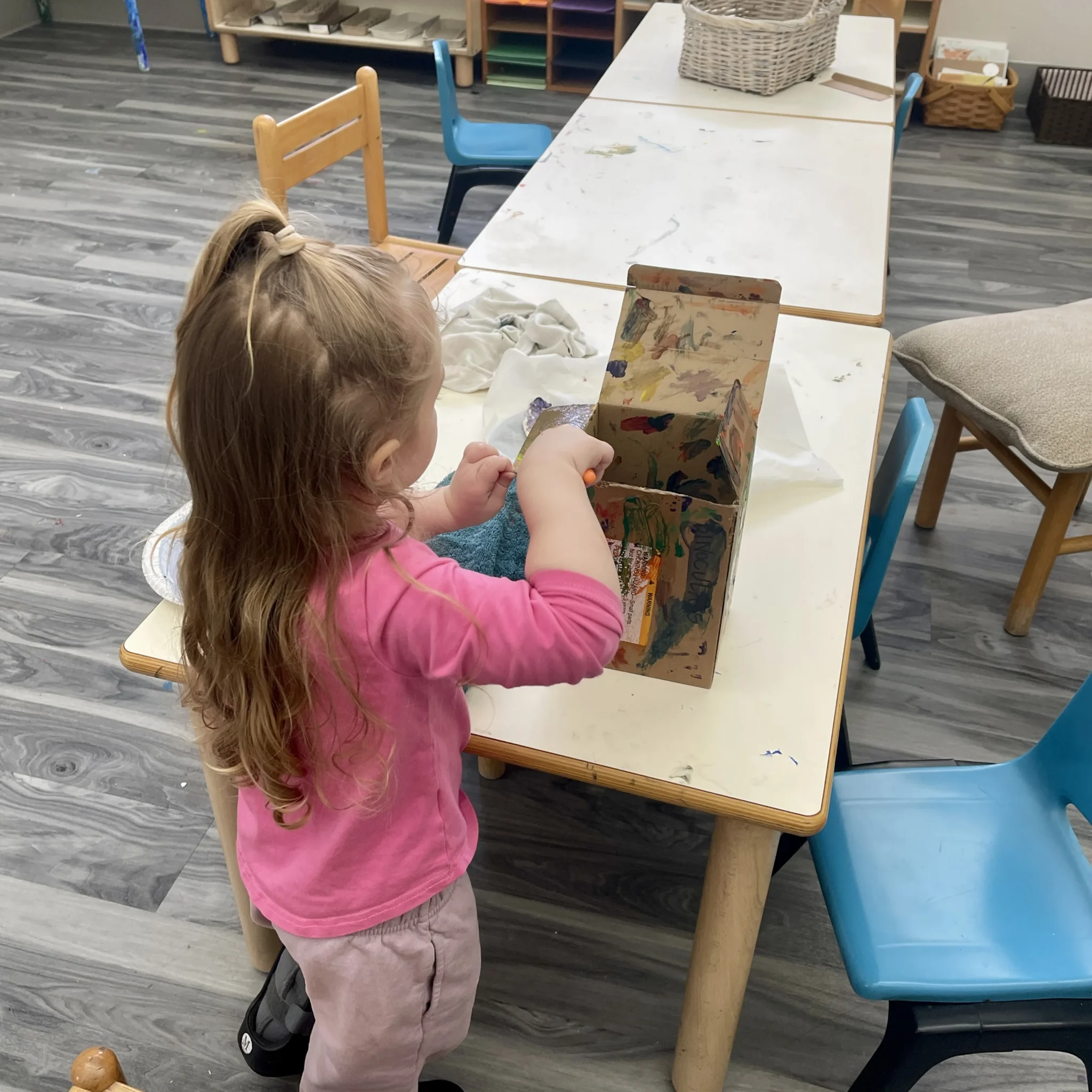 Preschool children creating colorful artwork during class